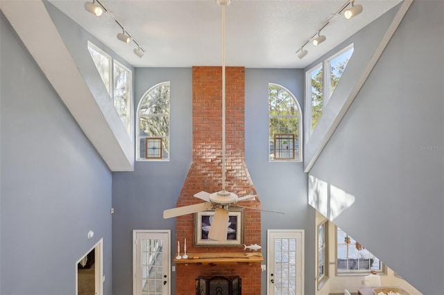 interior space with rail lighting and ceiling fan