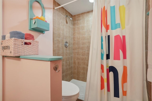 bathroom featuring toilet and a shower with shower curtain