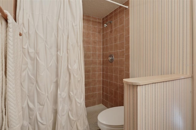 bathroom with toilet, a textured ceiling, and a shower with shower curtain