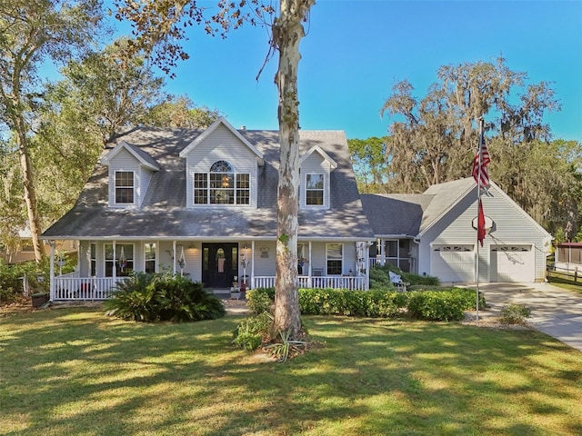 cape cod-style house with a front lawn and a garage