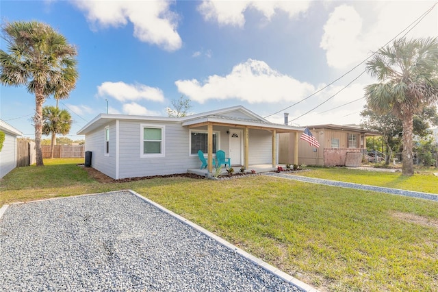 view of front of property featuring covered porch and a front yard