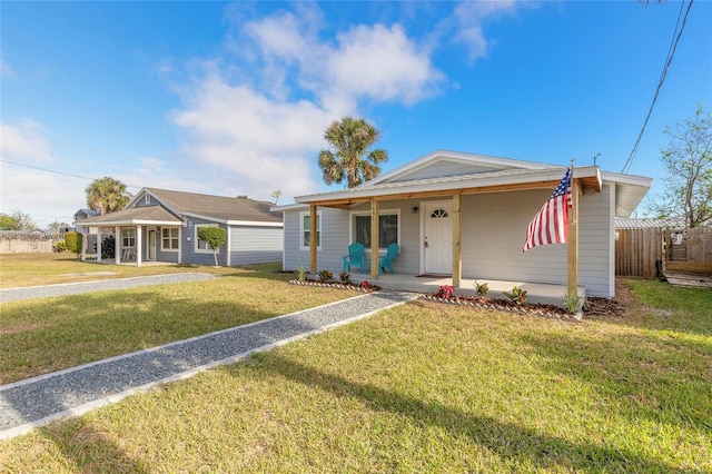 single story home with covered porch and a front yard