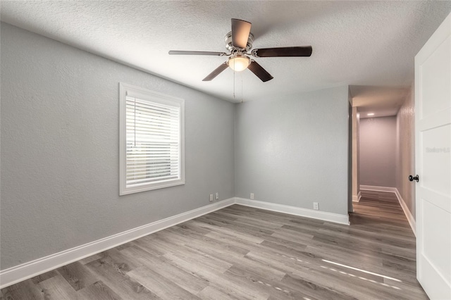 spare room featuring ceiling fan, a textured ceiling, and hardwood / wood-style flooring