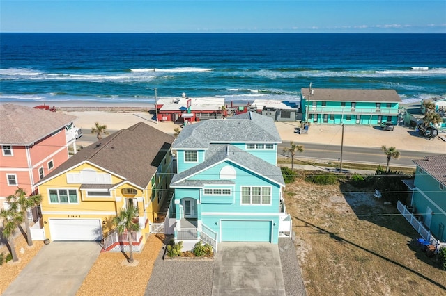 aerial view with a water view and a beach view