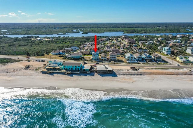 birds eye view of property featuring a view of the beach and a water view