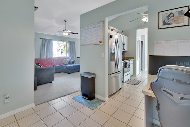 kitchen featuring white cabinets, ceiling fan, light tile patterned flooring, and appliances with stainless steel finishes