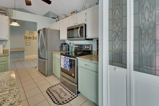 kitchen featuring pendant lighting, stainless steel appliances, white cabinetry, and lofted ceiling