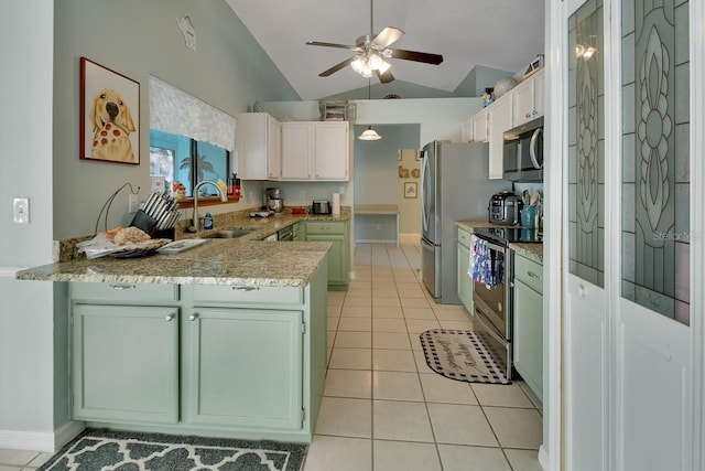 kitchen featuring kitchen peninsula, appliances with stainless steel finishes, sink, light tile patterned floors, and white cabinets