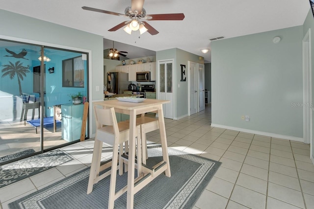 dining area featuring ceiling fan and light tile patterned floors