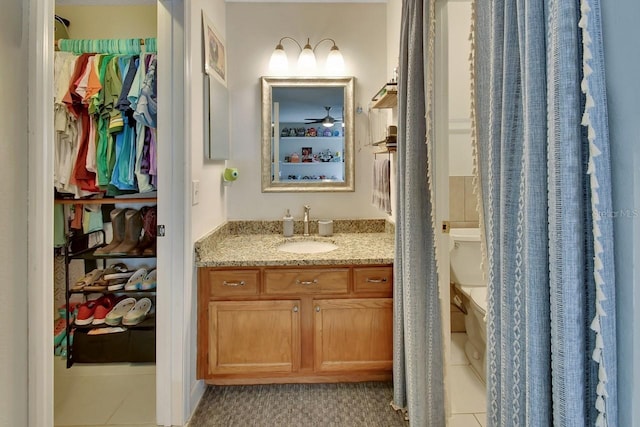 bathroom featuring tile patterned floors, vanity, and toilet