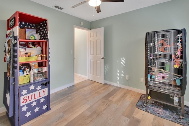 miscellaneous room featuring ceiling fan and wood-type flooring