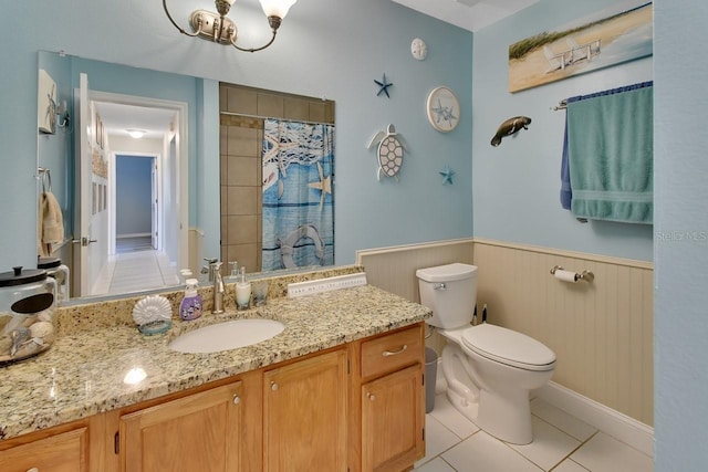 bathroom featuring tile patterned floors, curtained shower, vanity, and toilet