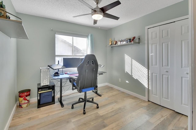 office with ceiling fan, a textured ceiling, and light wood-type flooring