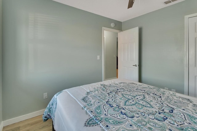 bedroom with ceiling fan and light hardwood / wood-style floors