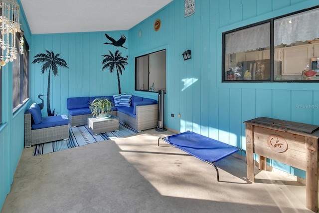 living room featuring wooden walls and lofted ceiling