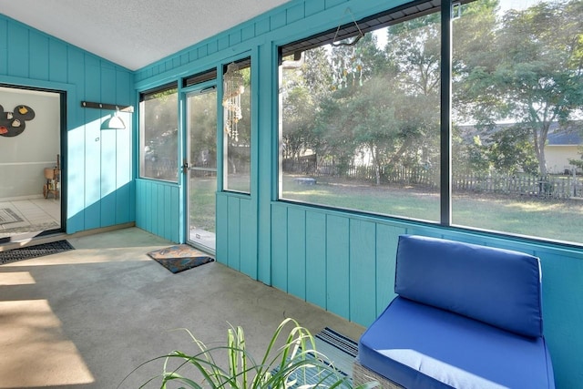 unfurnished sunroom featuring lofted ceiling