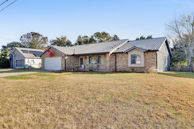 ranch-style home featuring a garage and a front lawn