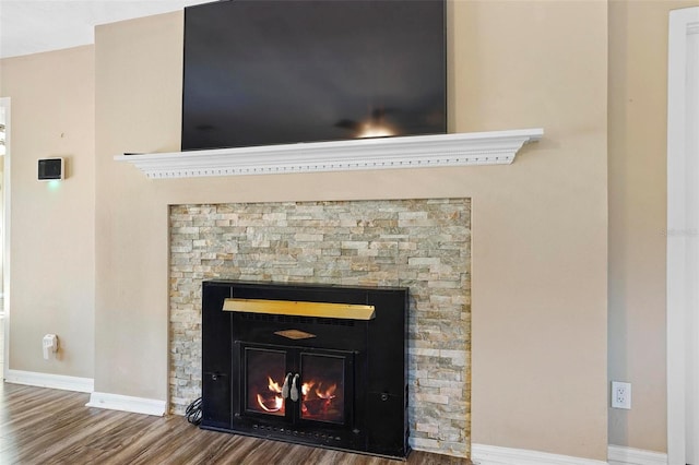 details with a fireplace and wood-type flooring