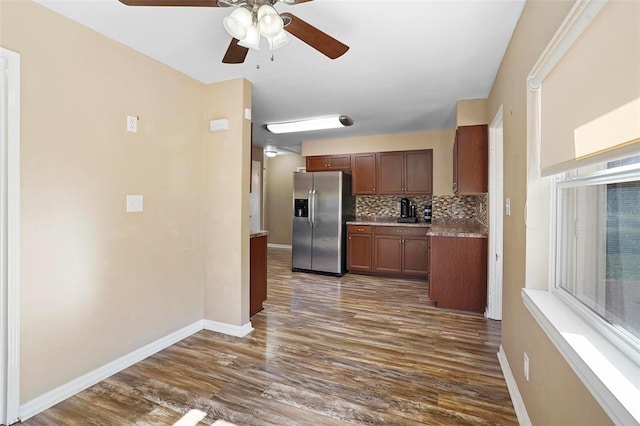 kitchen with tasteful backsplash, ceiling fan, dark wood-type flooring, and stainless steel refrigerator with ice dispenser