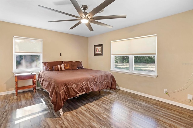 bedroom with ceiling fan and dark hardwood / wood-style floors