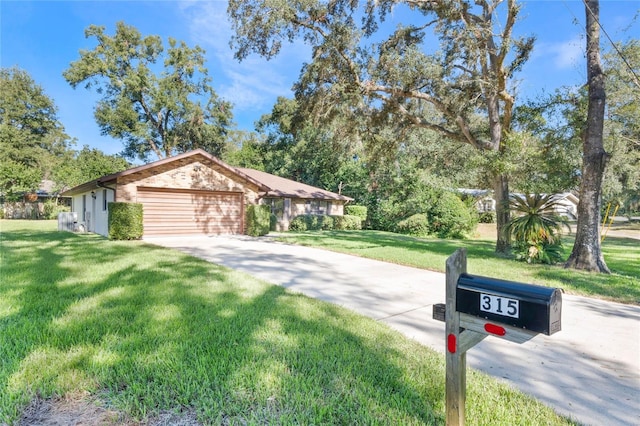 ranch-style home with a garage and a front lawn