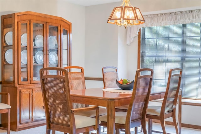 dining area featuring a healthy amount of sunlight and a notable chandelier