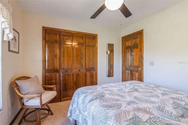 bedroom with carpet, a textured ceiling, a closet, and ceiling fan