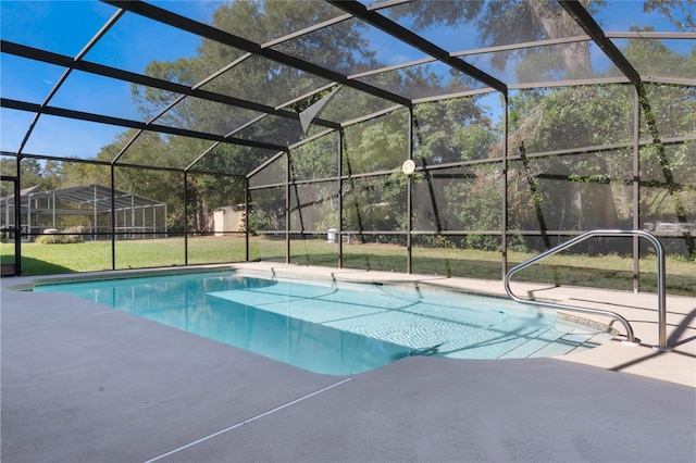 view of swimming pool with glass enclosure and a patio area