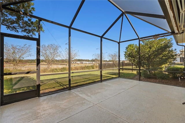 unfurnished sunroom featuring a rural view