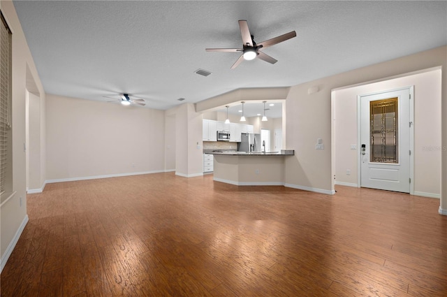 unfurnished living room with a textured ceiling, light hardwood / wood-style floors, and ceiling fan