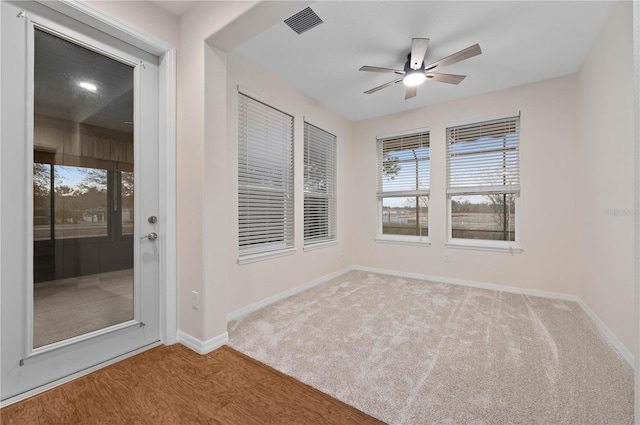 spare room with ceiling fan, a healthy amount of sunlight, and light hardwood / wood-style flooring