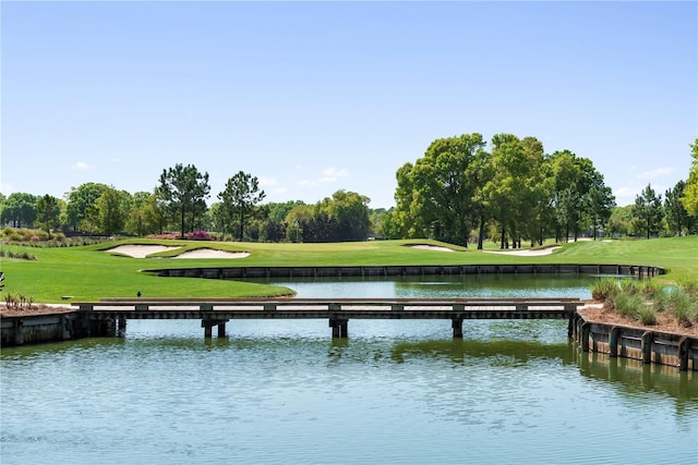 exterior space featuring a lawn and a water view