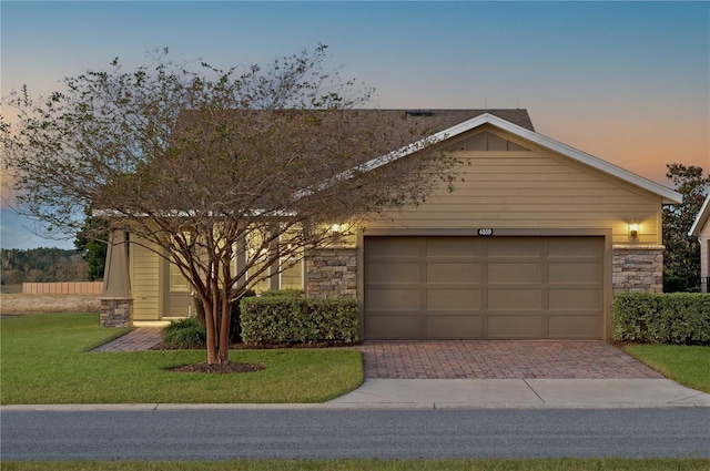 ranch-style house with a lawn and a garage