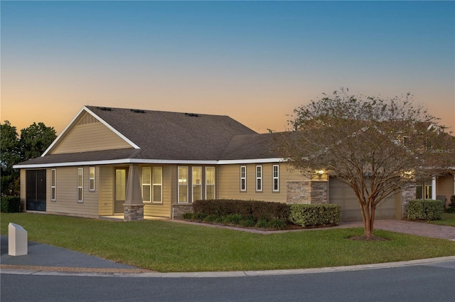 view of front of house with a garage and a lawn