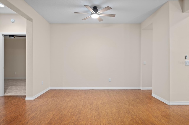 empty room with light wood-type flooring and ceiling fan