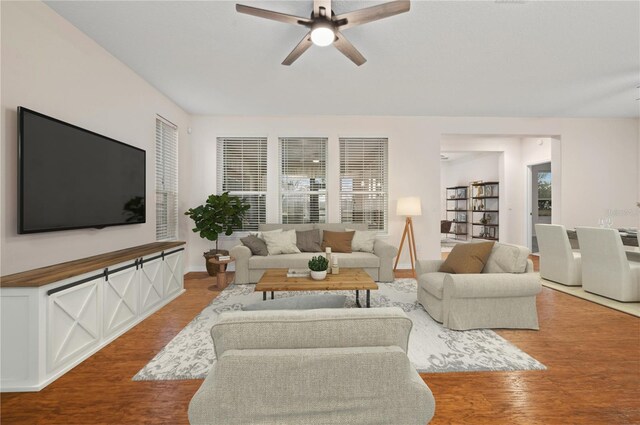 living room with hardwood / wood-style floors and ceiling fan