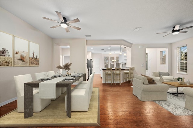 dining room featuring wood-type flooring and ceiling fan