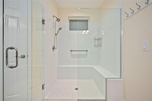 bathroom with a shower with door