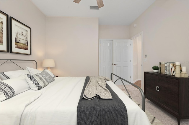 bedroom featuring ceiling fan, light colored carpet, and a closet