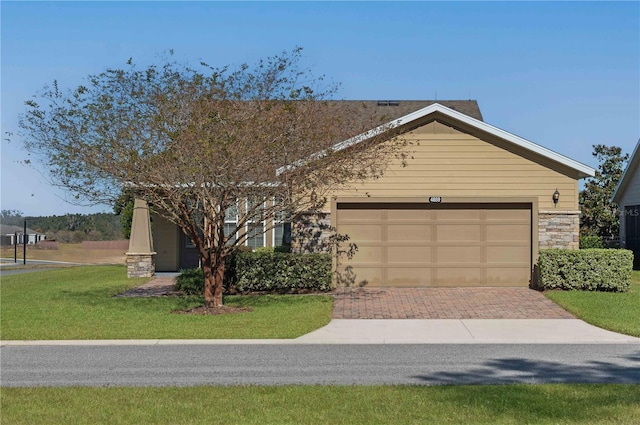 view of front of home with a front yard and a garage