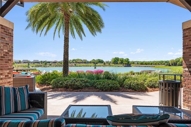 view of patio with outdoor lounge area and a water view