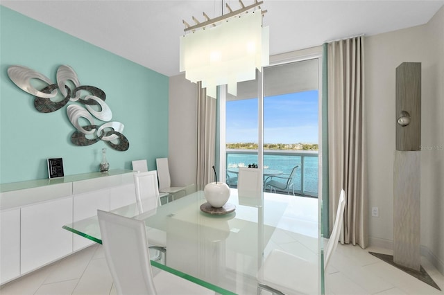 tiled dining area featuring a water view