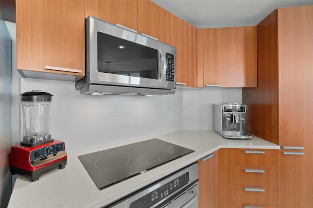 kitchen with backsplash and appliances with stainless steel finishes