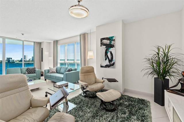 living room with light tile patterned floors, a textured ceiling, and a water view