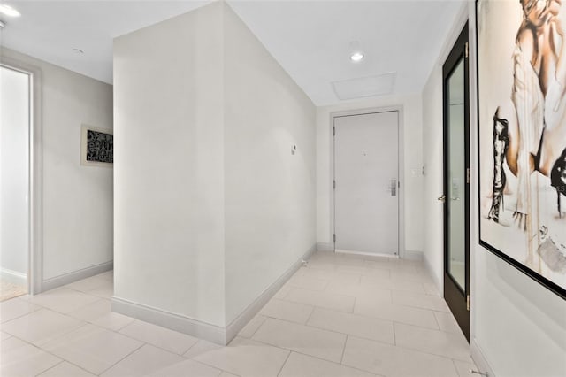 hall featuring light tile patterned floors