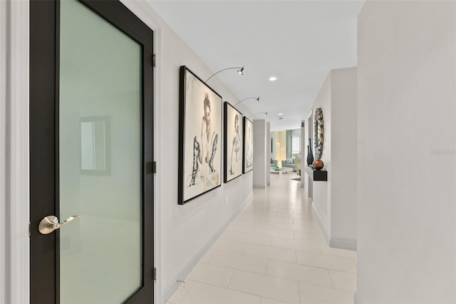 hall featuring light tile patterned flooring