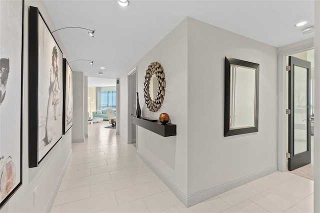 hall with light tile patterned floors