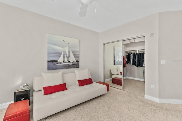 carpeted living room with ceiling fan