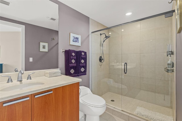 bathroom featuring vanity, toilet, and walk in shower