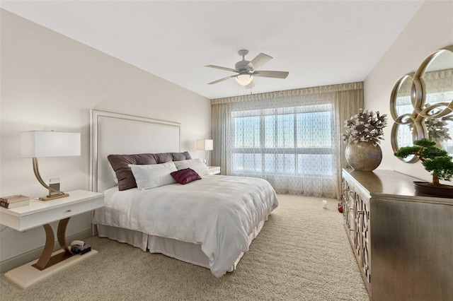 bedroom featuring light carpet, vaulted ceiling, and ceiling fan